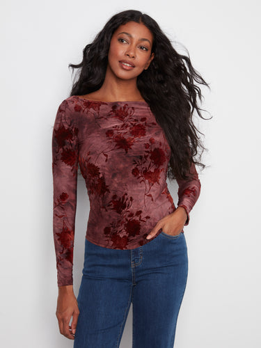 Elegant top with a boat neckline, featuring a stunning floral pattern in rich hues. Perfect for casual or formal wear by Charlie B.
