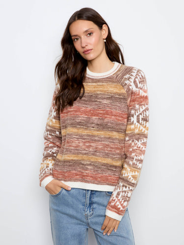 The sweater showcases a classic crew neckline that adds an elegant touch to its cozy design. By Charlie B.
