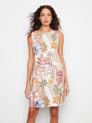This knee-length dress showcases side button detail, adding a unique flair to the colorful floral design perfect for warm days by Charlie B.