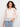 Crochet top with a boat neckline, showcasing intricate patterns and delicate design in a soft cotton blend. By Charlie B.