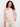 Crochet top in white with pink floral accents, featuring a boat neckline and 3/4 sleeves. Perfectly crafted by Charlie B.