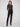 Black slim-fit dress pants with stretch fabric, featuring two back welt pockets for added style and comfort by Charlie B.