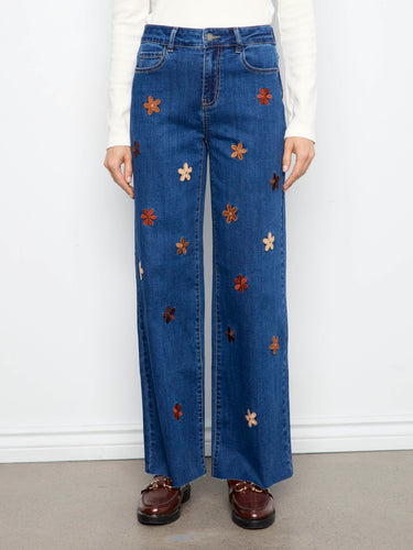 Embellished with flower embroidery, these jeans offer a playful yet elegant look. The suede patches enhance their unique design by Charlie B.