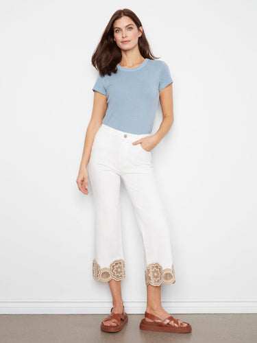 White cropped pants with intricate lace hem detail, offering a stylish touch to any outfit by Charlie B.