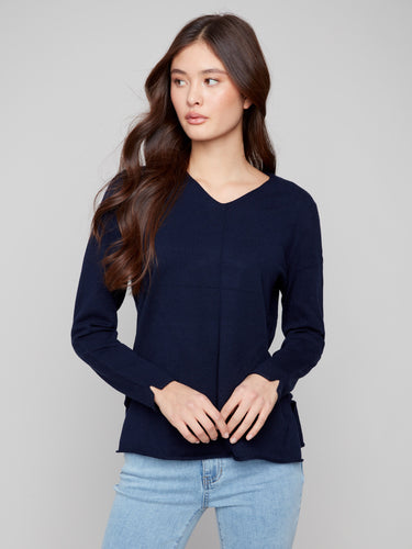 Sophisticated navy sweater with side slits on sleeves and hem, ideal for modern elegance by Charlie B.