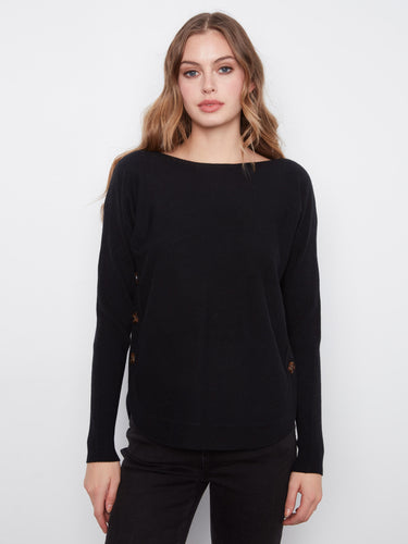 Black sweater with a boat neck and rounded hem, featuring elegant side button details by Charlie B.