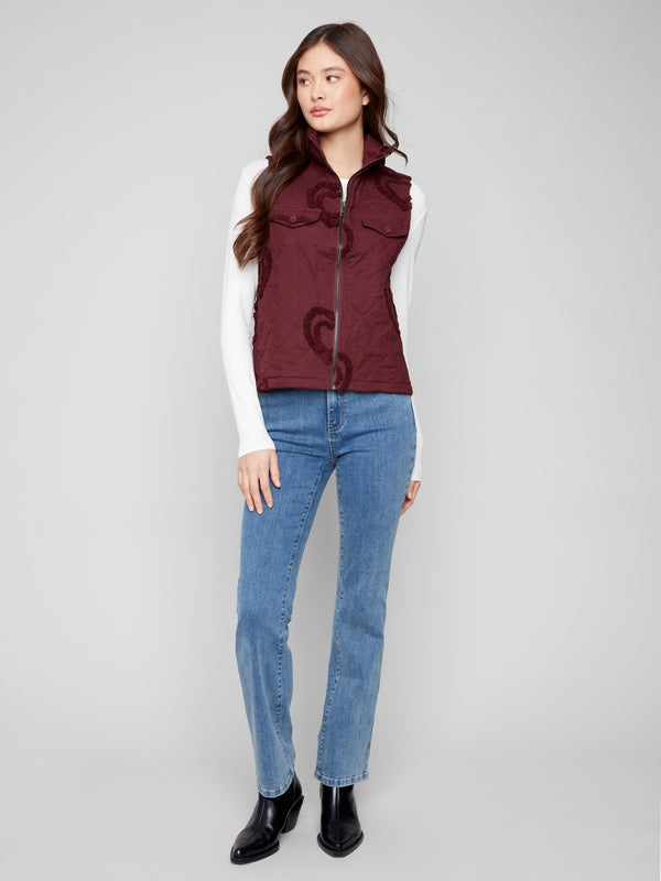 Stylish cabernet vest with functional welt pockets and charming boucle heart embellishments by Charlie B.