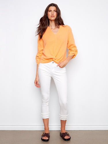 Chic orange blouse featuring long roll-up sleeves, perfect for versatile styling. Made from soft 100% cotton fabric by Charlie B.