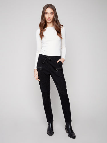 Black corduroy jogger pants featuring a slim fit and elastic waistband with drawstrings for comfort by Charlie B.