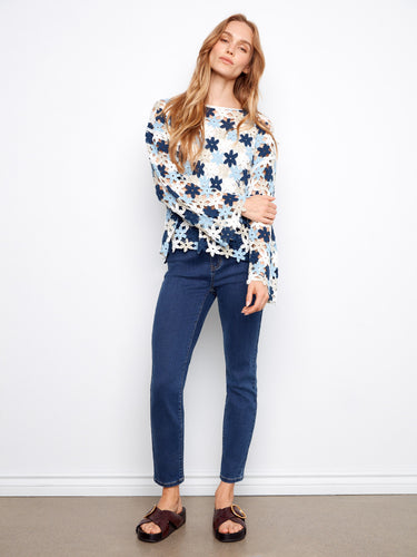 Featuring 3/4 sleeves, this crochet top is perfect for layering and adds a playful touch to any outfit. Designed by Charlie B.