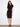 Elegant black dress featuring a boat neckline and waist tie for a flattering silhouette by Charlie B.
