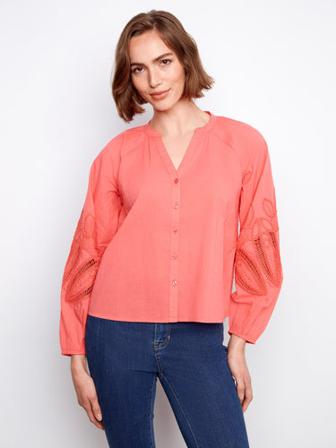 Coral blouse featuring a stand neckline and button-front closure, adding a touch of elegance to your wardrobe. By Charlie B.