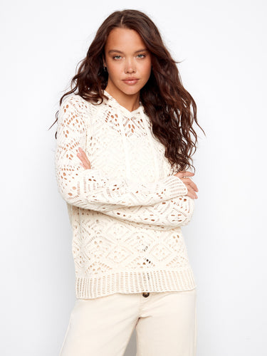 Stylish crochet hoodie sweater showcasing long raglan sleeves and intricate knit details, perfect for layering by Charlie B.