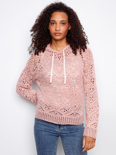Pink crochet sweater with a hooded design, featuring intricate patterns and soft texture for a cozy feel by Charlie B.