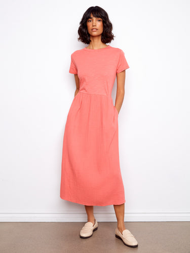 A coral midi dress featuring a classic crew neckline and short sleeves, crafted from 100% cotton for everyday comfort by Charlie B.