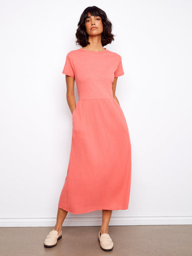 This dress showcases a flattering midi length with practical short sleeves, made entirely of breathable cotton by Charlie B.