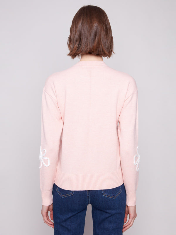 Chic long-sleeve sweater with ribbed detailing and charming floral soutache elements throughout by Charlie B.