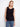 This sleeveless top features a classic crew neckline, perfect for layering or wearing alone. Designed by Charlie B.