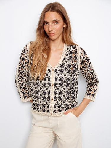 Intricate crochet top with a V-neck design, crafted in a delicate pattern with 3/4 sleeves for elegant style by Charlie B.