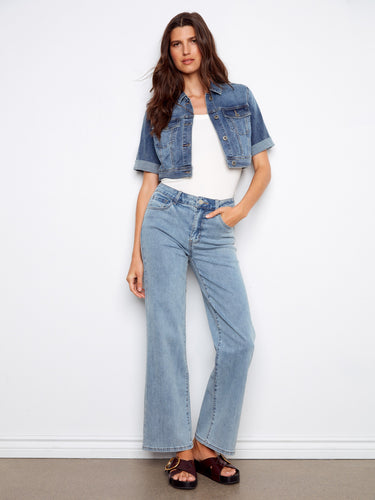 Denim jacket in medium blue featuring short rolled sleeves and chest flap pockets. A stylish staple by Charlie B.