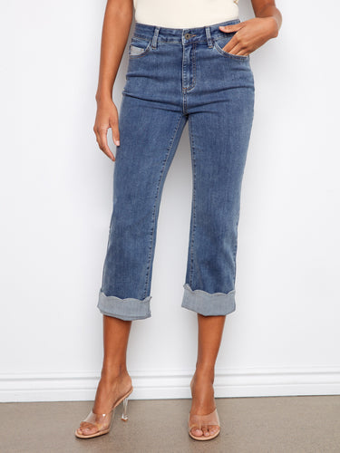Cropped denim in medium blue showcasing stretch fabric and classic five-pocket design, finished with scallop cuffs by Charlie B.