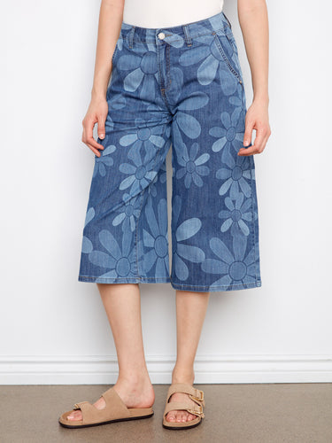 Wide-leg denim palazzo pants in a floral pattern, featuring stretch denim for added flexibility by Charlie B.