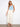 Natural twill pants in a straight fit, paired with a light blue top and sandals by Charlie B.