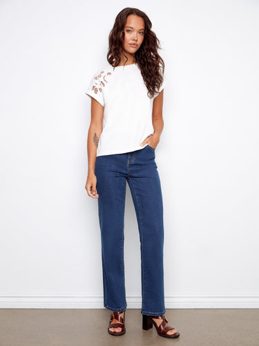 Elegant white top crafted from 100% cotton, highlighted by delicate shoulder embroidery by Charlie B.