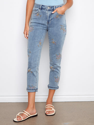 These cropped denim jeans feature five pockets and are adorned with delicate floral embroidery for added charm by Charlie B.