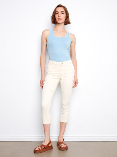 These pants feature a slim fit that enhances the silhouette, paired with a soft blue tank top for a casual look. By Charlie B.