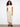 Beige wide-leg pants featuring a cropped length and drawstring waist, paired with casual sandals by Charlie B.