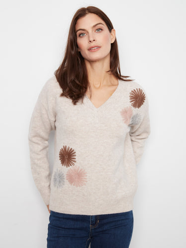 A cozy V-neck sweater featuring a relaxed fit, adorned with charming floral embroidery for a stylish touch. By Charlie B.