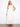Natural sleeveless dress featuring an elegant V-neckline and flowing maxi length by Charlie B.