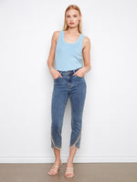 Denim jeans featuring a slim fit with a frayed embroidered tulip hem, adding a touch of elegance. By Charlie B.
