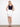 This skirt features a slim fit that flatters the silhouette, paired with a stylish navy tank top. By Charlie B.