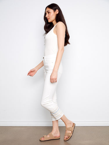 Chic white stretch denim jeans with an embroidered hem, offering a flattering slim fit and regular rise by Charlie B.