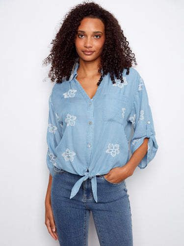 Blouse with collared V-neckline and floral embroidery, featuring a front tie and chest pocket by Charlie B.