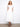 White V-neck dress featuring an empire elastic waist and hidden pockets by Charlie B.