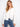 White denim jacket featuring frayed hem and eyelet details, complete with button closure and chest flap pockets by Charlie B.