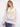 White fishnet hoodie sweater with long sleeves and a gold heart design by Charlie B.