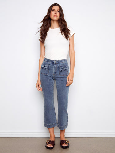 Denim pants with a stylish flared fit, featuring unique bow patch pockets for added charm. Crafted with attention to detail by Charlie B.