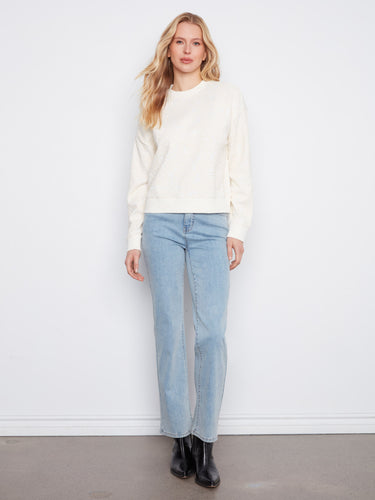 Elegant buttercream sweatshirt adorned with intricate floral soutache, featuring a comfortable relaxed fit by Charlie B.