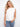 White sleeveless top with intricate floral embroidery, perfect for a summer day. Designed by Charlie B.