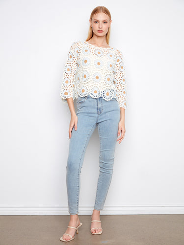 Charming handcrafted crochet sweater featuring a stylish boat neckline and exquisite floral patterns by Charlie B.