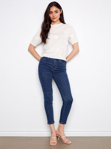 Elbow-sleeve cotton knit top in white with applique embroidery detail, paired with denim by Charlie B.