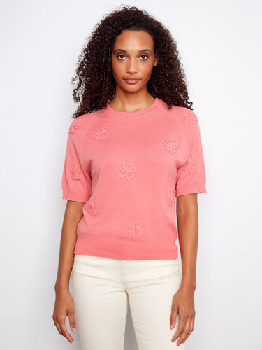 Pink top featuring a crew neckline and raglan sleeves, crafted from 100% cotton for comfort and style. By Charlie B.
