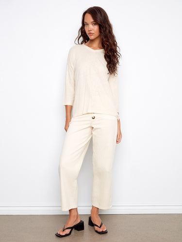 Versatile V-neck design with a relaxed silhouette, enhanced by the unique foiled effect on the fabric. By Charlie B.