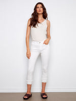 White cropped pants in stretch twill fabric with frayed hem details, offering a regular rise waist by Charlie B.