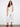 White cropped pants in stretch twill fabric with frayed hem details, offering a regular rise waist by Charlie B.