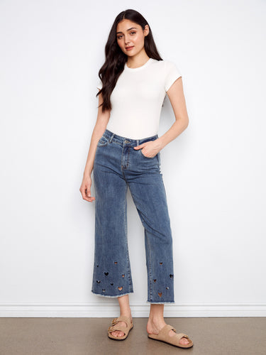 Medium blue wide-leg jeans with a cropped length, featuring heart cutouts and a five-pocket design by Charlie B.